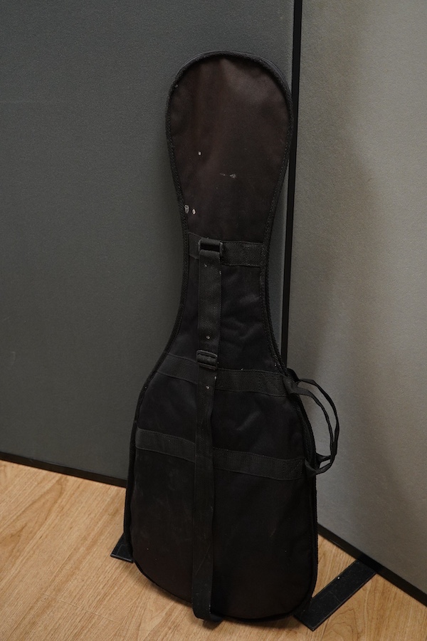 A Yamaha ERG121 electric guitar in black finish, with a soft gig case